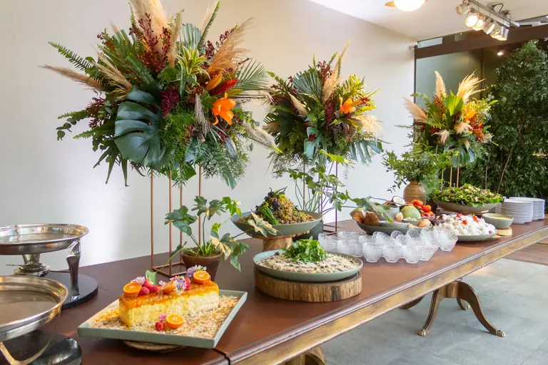 Beautiful wedding buffet table with floral decor and delicious desserts in São Paulo, Brazil.